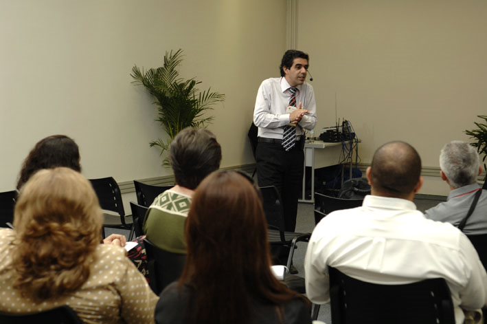 Julio Santos conduzindo uma palestra diante de participantes